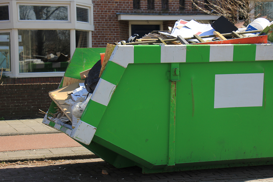 Loaded dumpster near a construction site, a home renovation or maintenance